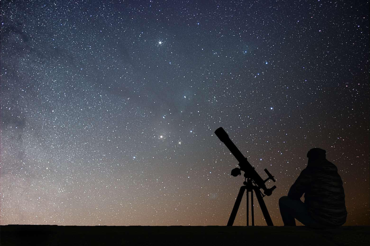 Man with astronomy  telescope looking at the stars.