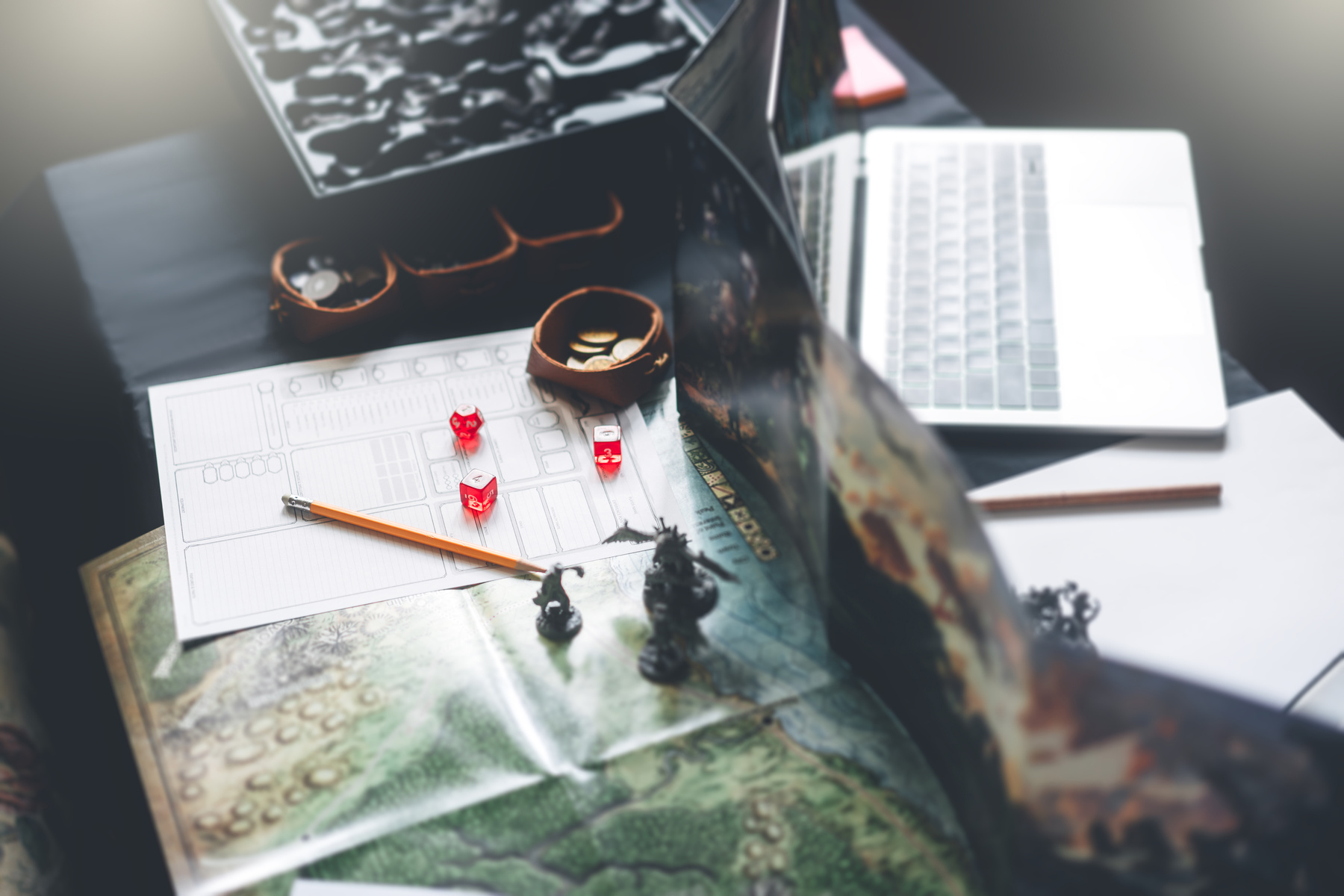 Dungeon master screen with dice and miniatures for role playing